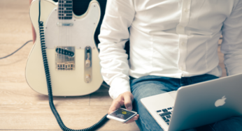 Man with guitar & Apple devices