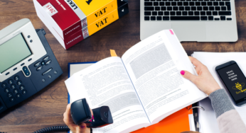Reading tax book in the office